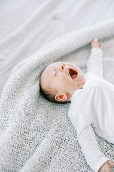 newborn baby yawning  during an in home newborn session