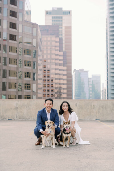 image of a couple with their two lovely dogs at the roof top of Downtown Austin, Texas