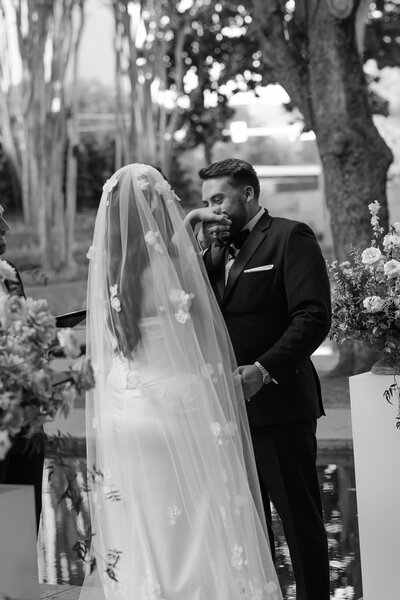 A romantic and intimate engagement session in the natural landscapes of Dallas-Fort Worth, featuring a couple nestled in tall golden grasses, sharing a quiet moment.