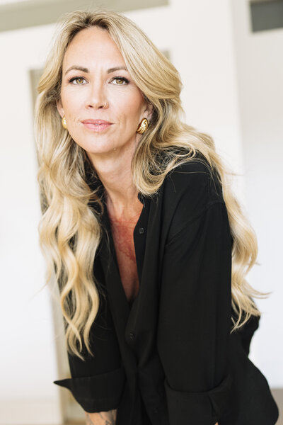 Aine Rock in a black button down shirt looking into the camera