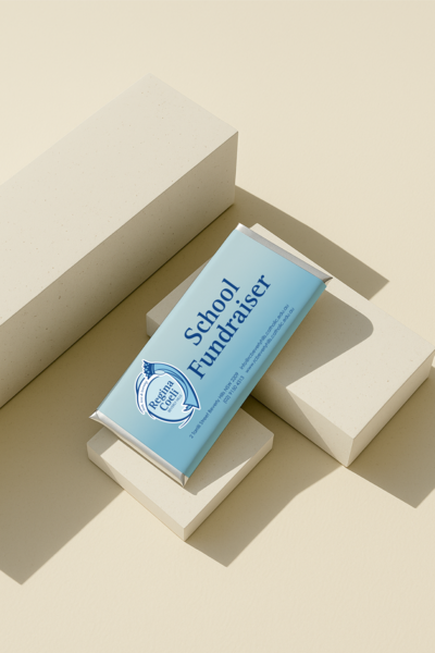 Luxury personalised chocolate bar in blue Regina Coeli School fundraiser design, crafted by Barilliant for school fundraising events and premium gifting.