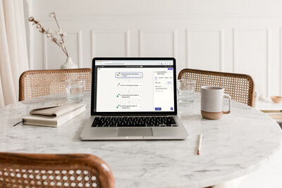 Laptop on marble table showing Zapier automation screenshot