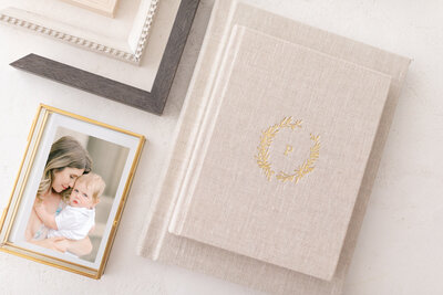 Keepsake gold photo box with loose prints of a mom and her baby