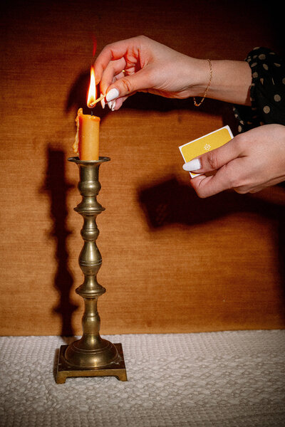 Woman striking a match and lighting a candle