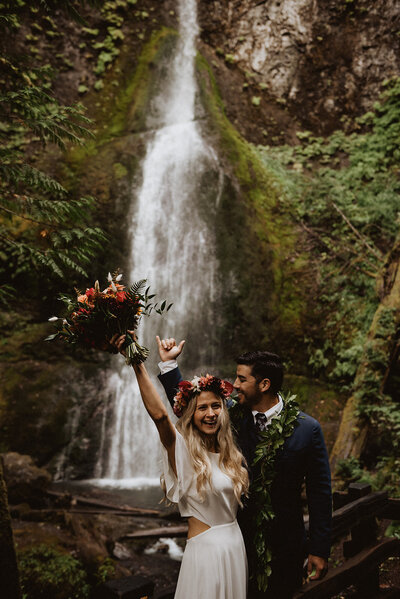 Just married in front of a waterfall