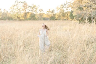 girl running in a field during Ashburn, VA senior session