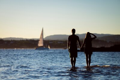 couple on holiday looking at boat