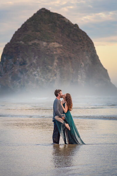 A romantic and sexy photo of a couple in the water at cannon beach oregon