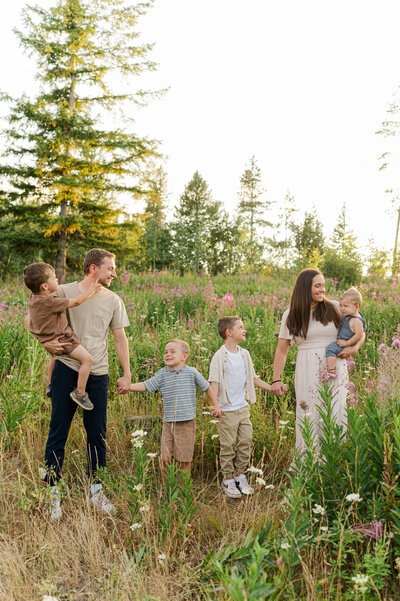 brother tickling baby and family laughing