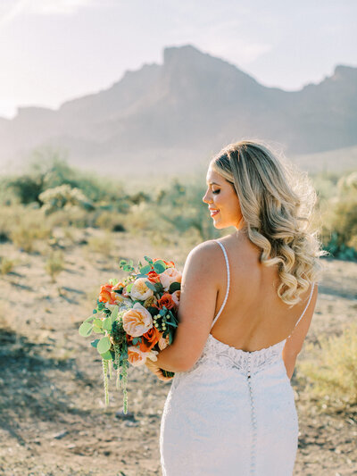 bride looking to the side while holding flowers