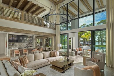 Natural light modern living room with open kitchen and second story den.