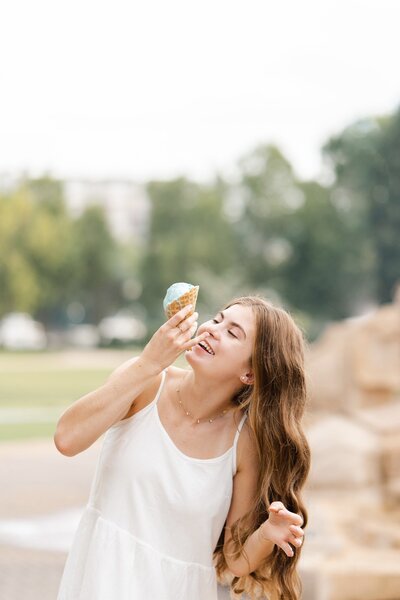 Chattanooga senior eats ice cream cone from Clumpies at Coolidge Park during senior portraits