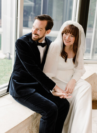 Bride sitting on geometric print couch at proper hotel and Laguna Gloria Intimate Wedding