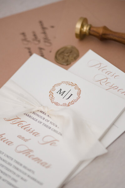 Letterpress monogram invitation with white ribbon