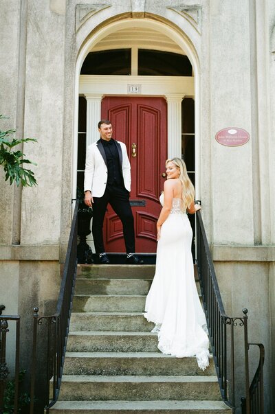 Bride holding Bouquet beside pillars