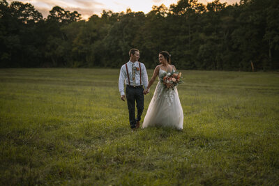 Couple walking through field on their wedding day at a New Jersey