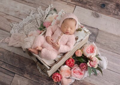 Newborn baby girl in a pink knit outfit