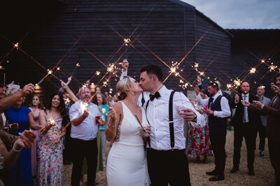 wedding sparkler exit with bride and groom surrounded by guests