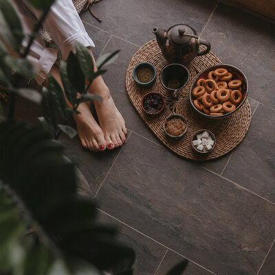 Woman sitting on the floor enjoying a tea break, symbolising Financial Sustainability.