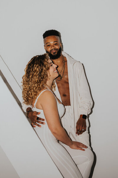 couple smiling wearing matching track suits