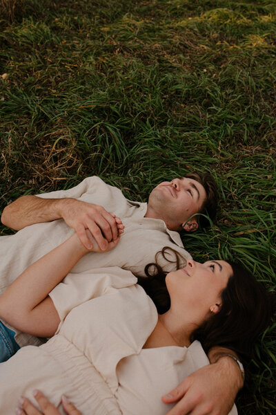 Romantic Omaha engagement session during the fall, captured by Tori Nichole Photography. The couple is surrounded by vibrant autumn foliage and golden light, creating warm, timeless moments. A perfect blend of natural beauty and authentic connection, showcasing the magic of the season and their love story.