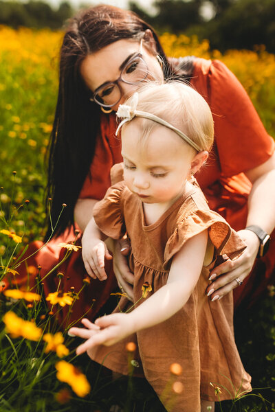 Baby girl picking flowers for her mommy