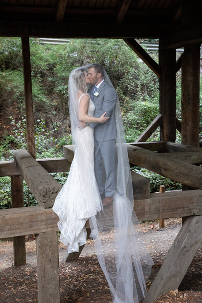 bride and groom on Mill Park Bridge