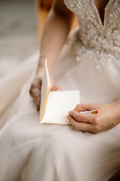 Bride holding up a bouquet of flowers during a beach elopement in Michigan.