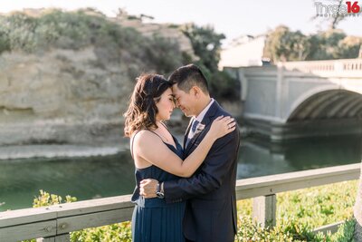 Engaged couple embrace in a tender moment overlooking Aliso Beach in Laguna Beach