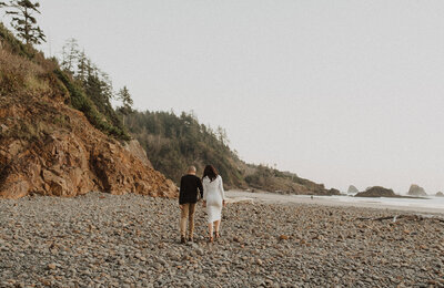 Couple walking along the Oregon Coast for their engagement session