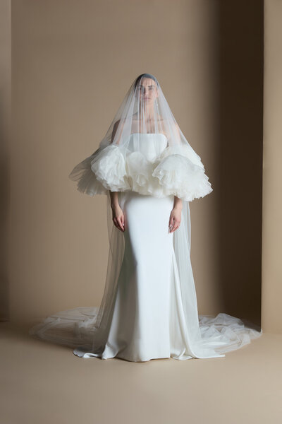 black and white image bride wearing strapless satin wedding dress with long train
