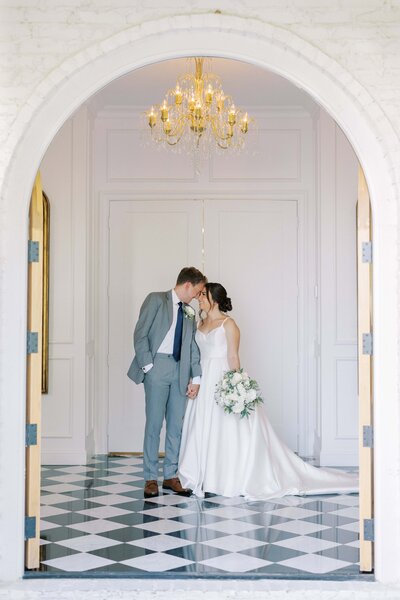 Bride and groom inside the  Nest at Ruth Farms chapel looking at each other