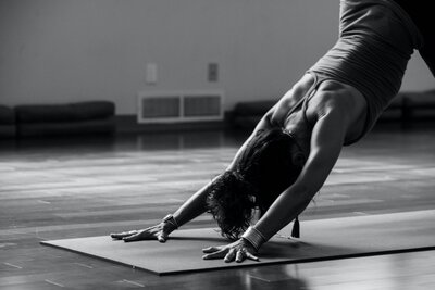Yoga practitioner in Downward Dog pose in San Miguel De Allende, promoting flexibility, core strength, and mindful movement in a tranquil studio setting.