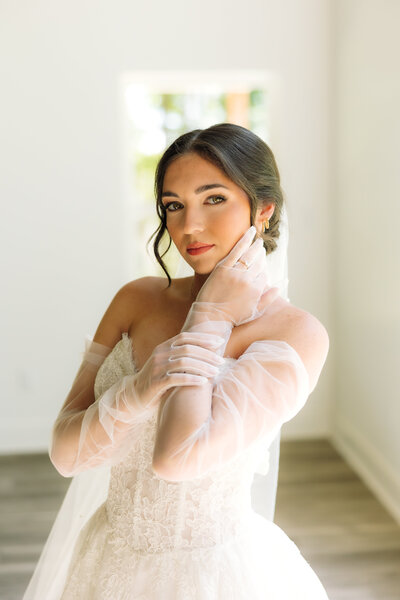 Bride surrounded by bouquets of flowers.