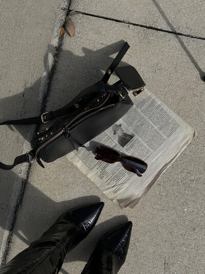 Black bag and newspaper on the floor