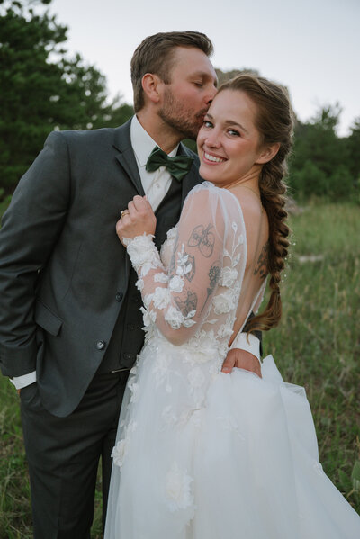 White chapel with cross at peak and sun beaming behind