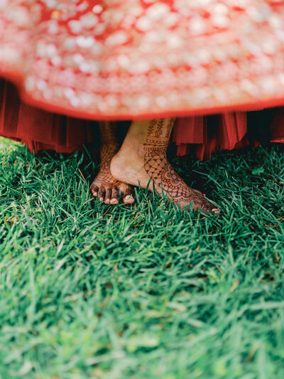 Portrait of a Hindu bride's henna on her feet as she twirls before her Sikh ceremony.