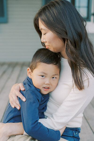 a young boy hugging his mom