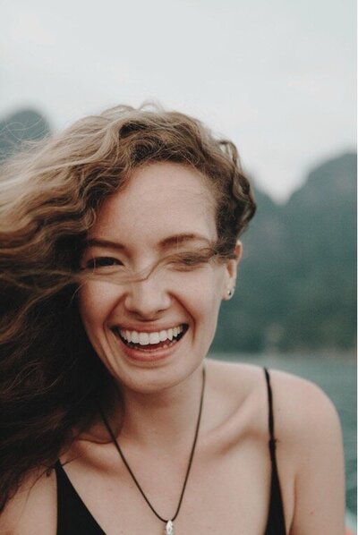 Wind in womans hair laughing