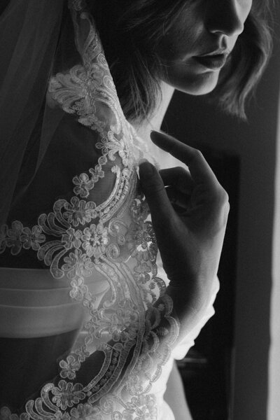 Close up black and white intimate image of bride getting ready before her wedding. Captured by Nicci K Photography