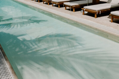 Luxury beachfront resort in Mexico with turquoise pool and modern cabanas, perfect for destination weddings.