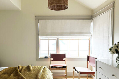 Boston interior designer creates a South Shore primary bedroom with corner windows and simple modern interiors for a fresh coastal retreat.
