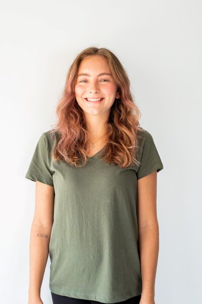 Ms. Kaleigh, our assistant teacher at the Nest in Surf City posing for her headshot