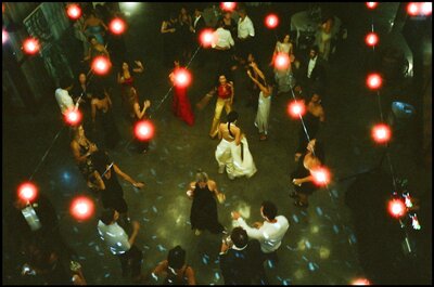 Bride and her bridesmaids laughing on a city street