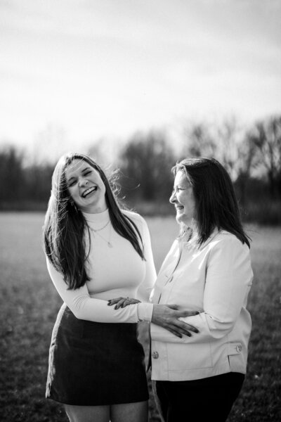 Mother and daughter laughing during outdoor family photography session in Champaign-Urbana, IL by Light By Zoey Photography.