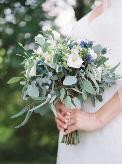 White bouquet being held by a bride