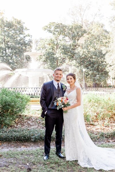 A joyful portrait of Sarah + Timothy after their elopement ceremony at Forsyth Park, "Near The Fountain" in Savannah, captured as part of our Savannah Elopement Package.
