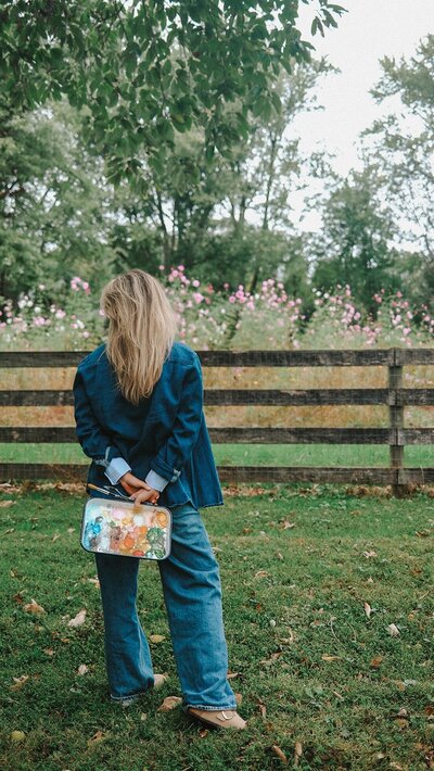 Image of east Coast stationery designer standing with paint palette outside
