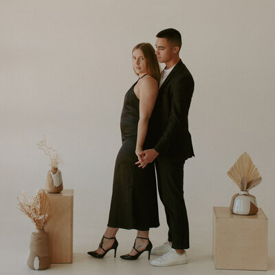 This couple did a photoshoot in a studio to announce their pregnancy. They wore all black and used pampas grass to give a really modern high end look to their photos.