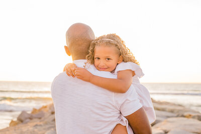 Family Photography, couple playing with their toddler at the beach